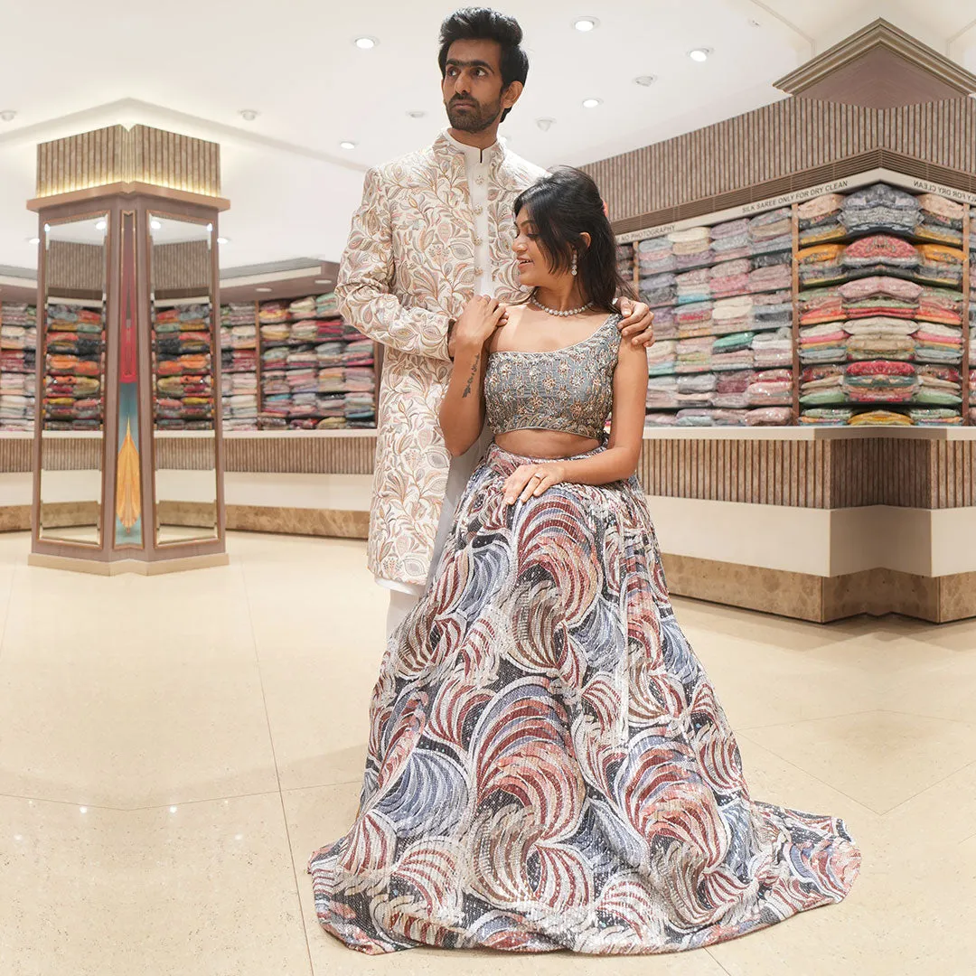 Abstract Blue Indo-Western Lehenga Set Complimented with Men's White Embroidered Sherwani
